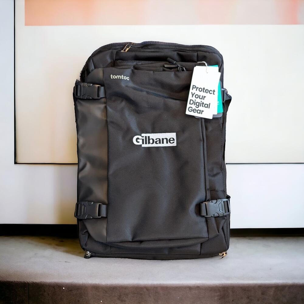 Gilbane logo custom embroidered on a black travel backpack